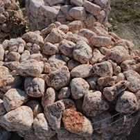 Tumbled pebbles of Rosso Asiago marble