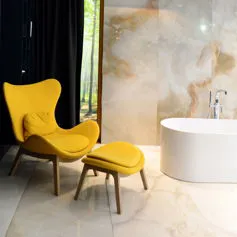 Onyx marble bathroom with modern chair