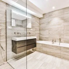 Navona Travertine marble bathroom with open-pore polished countertop