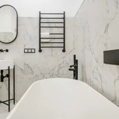 Polished Statuario marble bathroom with black steel elements