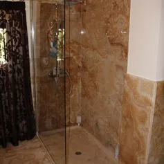 Onyx Honey marble bathroom with a classy shower